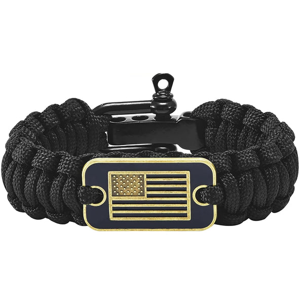 Black paracord survival bracelet with a bronze American flag charm and a black metal clasp.