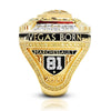 A close-up of a gold championship ring featuring the text VEGAS BORN MARCHESSAULT 81 and the year 2023.