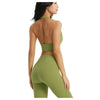 A model wearing a sage green halter neck sports bra top and matching leggings, shown from the back.
