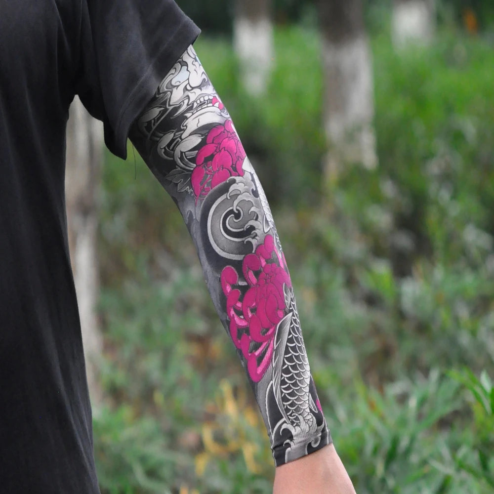 Close-up of a person wearing black clothing with a pink and gray dragon tattoo sleeve on their arm.