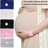 A collection of anti motion sickness and anti morning sickness wrist straps in various colors shown on a pregnant woman's arm