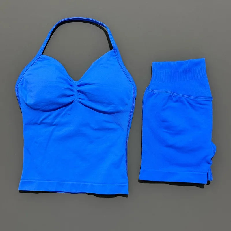 A bright blue women's seamless backless fitness set consisting of a cropped top and long sleeves.