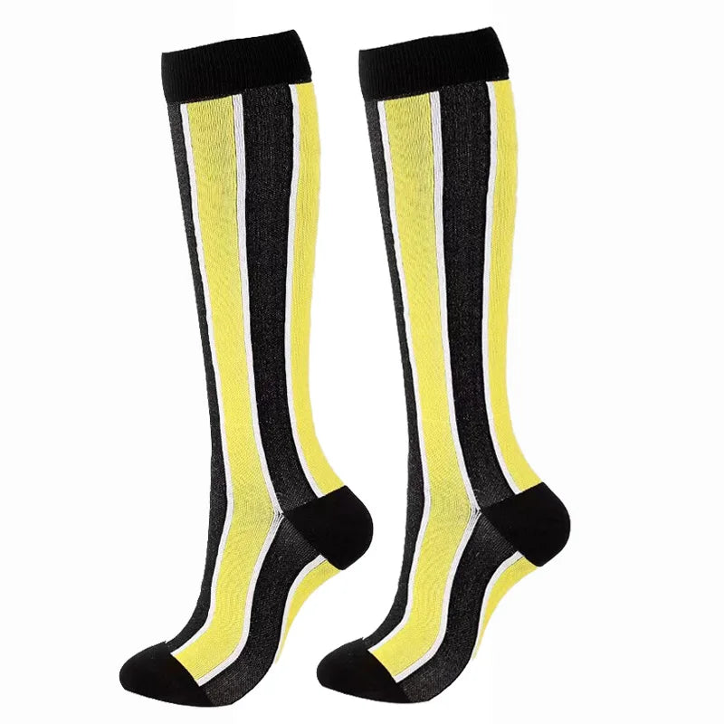 A pair of black and neon yellow compression elastic socks for sports and daily wear.