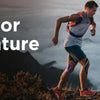 A man running outdoors in a scenic, misty landscape.