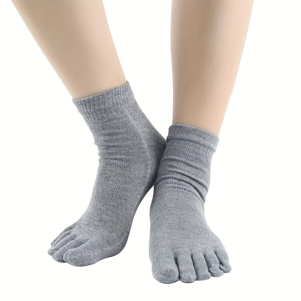 A pair of gray men's breathable cotton split toe socks shown on a foot.