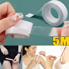 Close-up of invisible double-sided fashion tape being applied to skin and fabric.