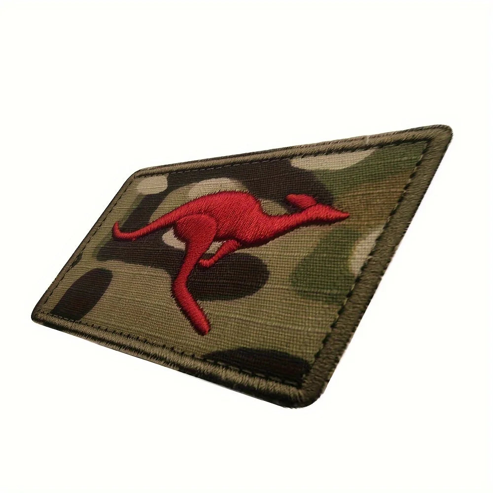 An embroidered patch featuring a red kangaroo silhouette on a camouflage background.