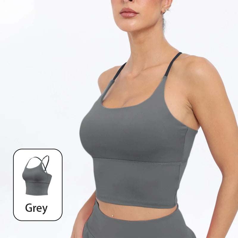 A model wearing a grey summer strappy yoga sports bra with built-in padding.