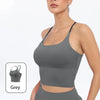 A model wearing a grey summer strappy yoga sports bra with built-in padding.