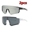 A pair of clear and gray cycling sunglasses are shown, with one pair featuring white frames.