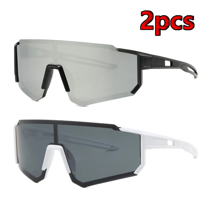 A pair of clear and gray cycling sunglasses are shown, with one pair featuring white frames.