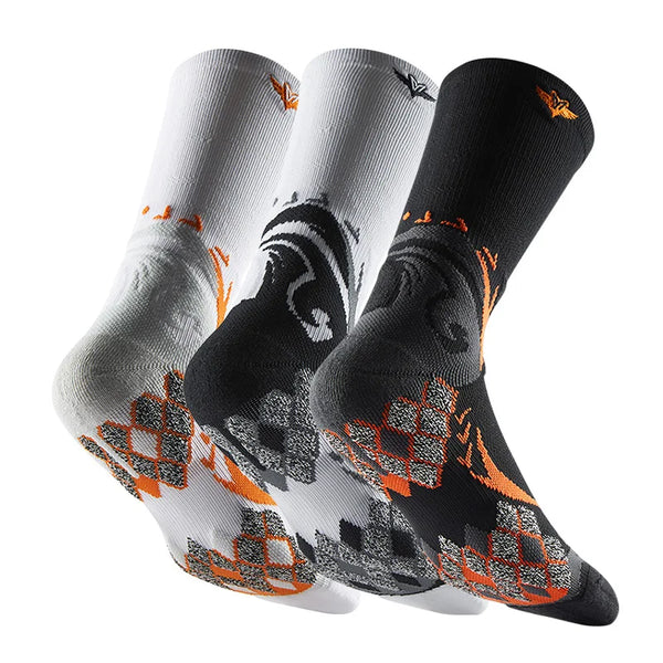 A set of three black athletic socks with orange and gray patterns shown from the side.