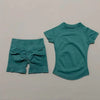 A teal seamless yoga set for women featuring a short sleeve top and workout leggings.