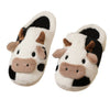 Pair of cartoon cow winter home slippers with white and black fur patterns