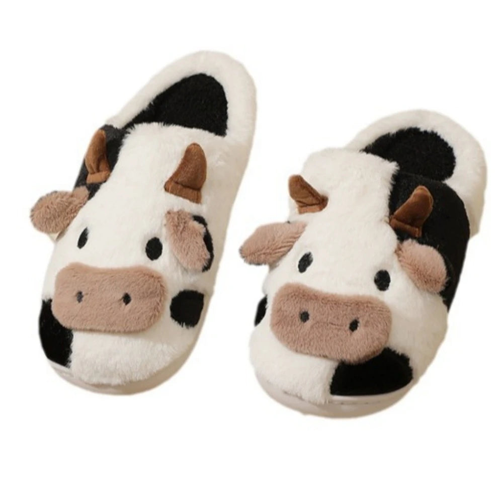 Pair of cartoon cow winter home slippers with white and black fur patterns