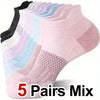 A stack of five pairs of mixed color performance compression ankle socks shown from above.
