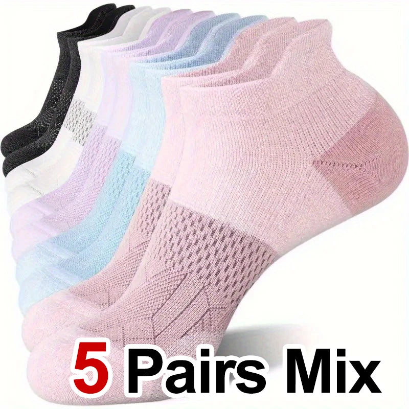A stack of five pairs of mixed color performance compression ankle socks shown from above.
