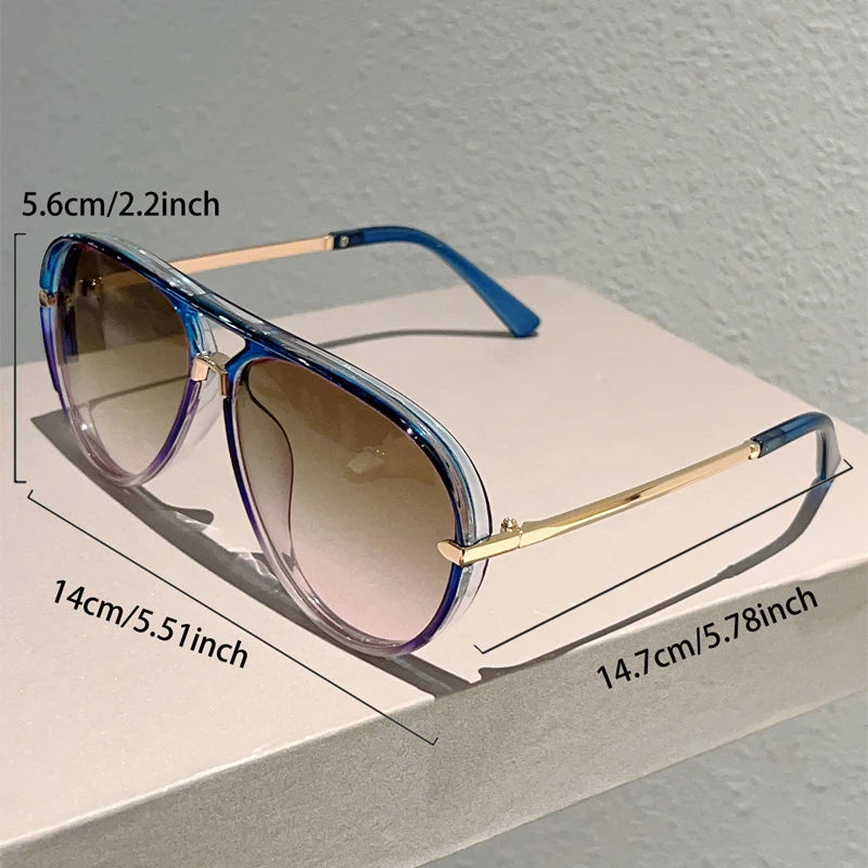 Vintage pilot gradient sunglasses with blue frames and tinted lenses shown on a white surface.
