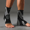 A person's lower leg wearing black and white compression sleeves for ankle support.