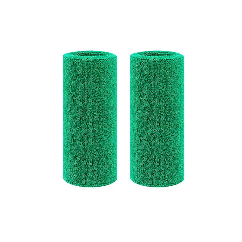A pair of green dual sports wristbands designed for sweat absorption.