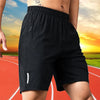 A person wearing black men's quick dry jogging shorts outdoors