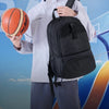 A person wearing a white shirt and dark pants is holding an orange basketball and carrying a black multi-sport fitness backpa