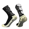A pair of black and white anti-slip training socks shown from the side.