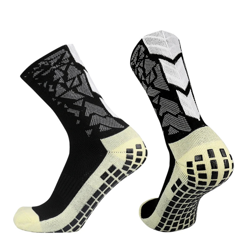 A pair of black and white anti-slip training socks shown from the side.