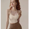 A woman wearing a beige supportive sports bra and matching leggings posing for a studio photo.