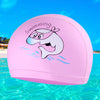 A pink cartoon swimming cap featuring a smiling whale splashing water in clear blue ocean water.