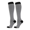 A pair of black and white striped compression elastic socks for sports and daily wear.