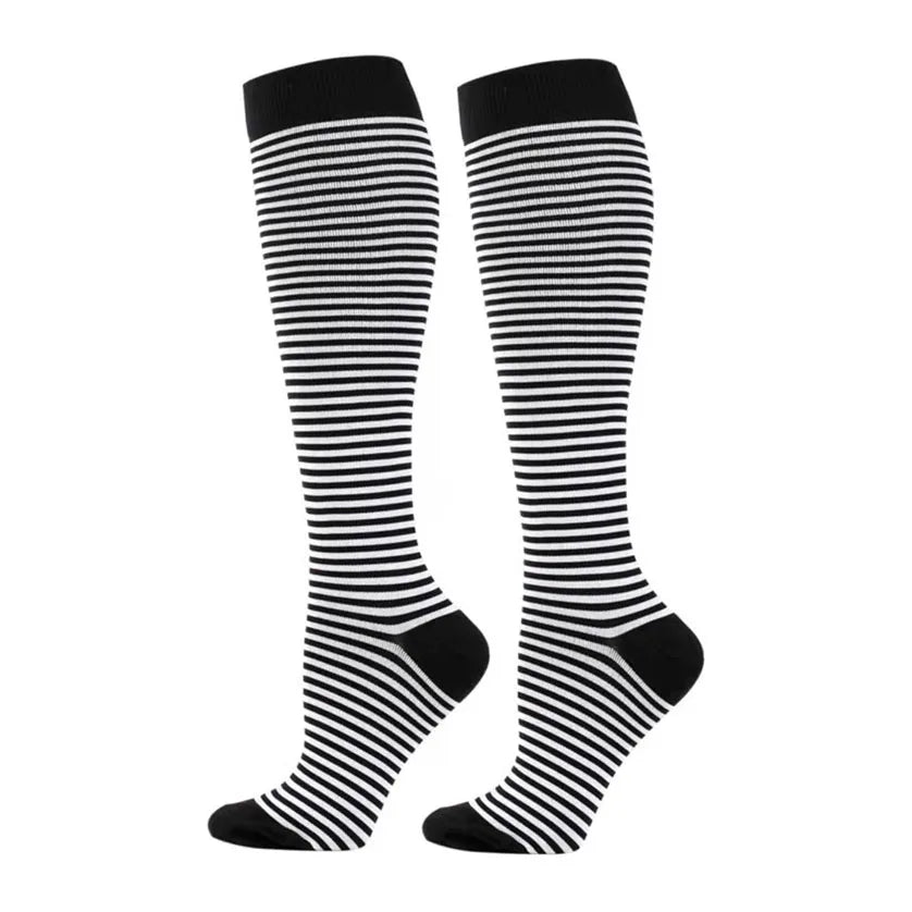 A pair of black and white striped compression elastic socks for sports and daily wear.