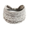 A stack of beige bohemian cotton stretch headbands with intricate patterns.