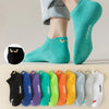 A variety of colorful ankle boat socks are displayed, including green, yellow, purple, and black options.