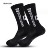 A pair of black anti-slip performance sports football socks shown from the side.