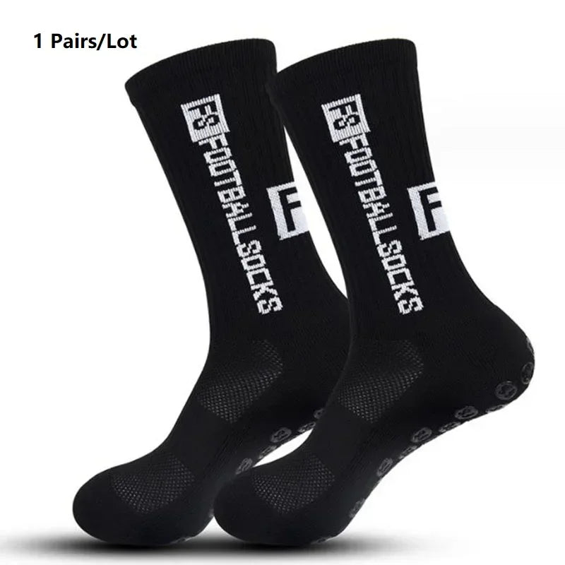 A pair of black anti-slip performance sports football socks shown from the side.