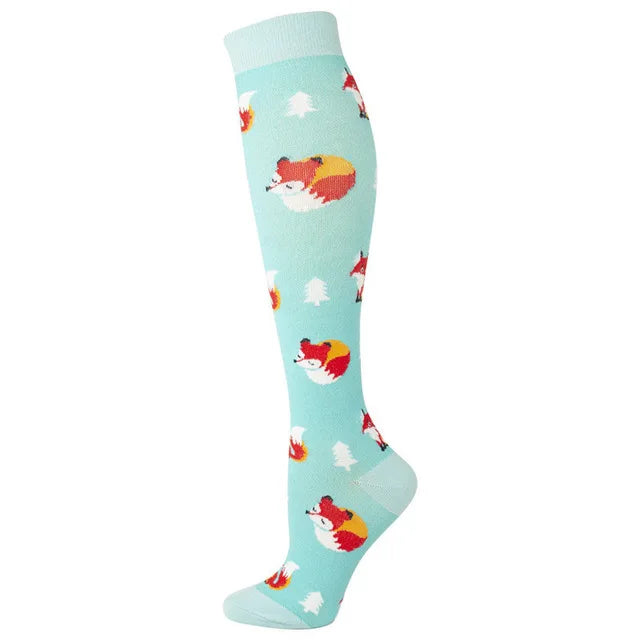 A pair of light blue compression socks featuring repeating patterns of red and white fox faces.
