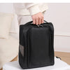 A hand is holding a black portable webbing bag, demonstrating its strong and firm handle.