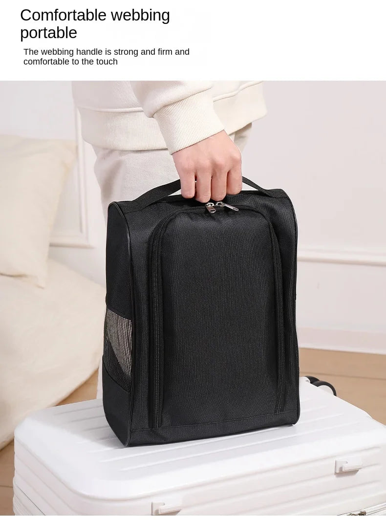 A hand is holding a black portable webbing bag, demonstrating its strong and firm handle.