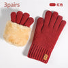 A pair of knitted red thermal gloves with a fluffy tan cuff shown against a white background.