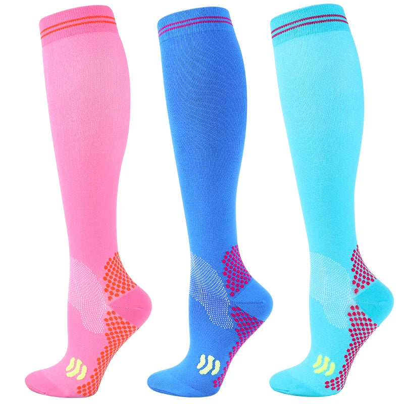 Three pairs of medical grade compression socks in pink, blue, and cyan showing different shades of leg support.