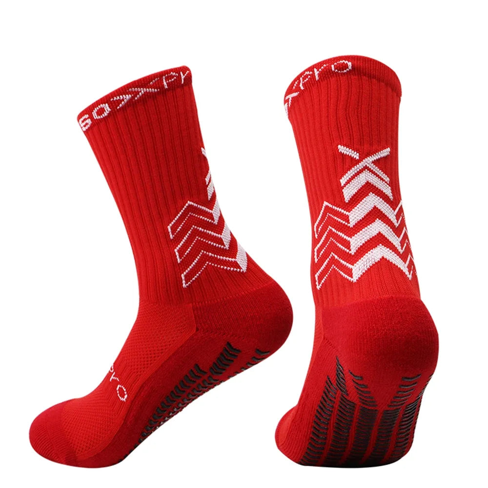 A pair of red athletic sports socks with white chevron patterns and black detailing.