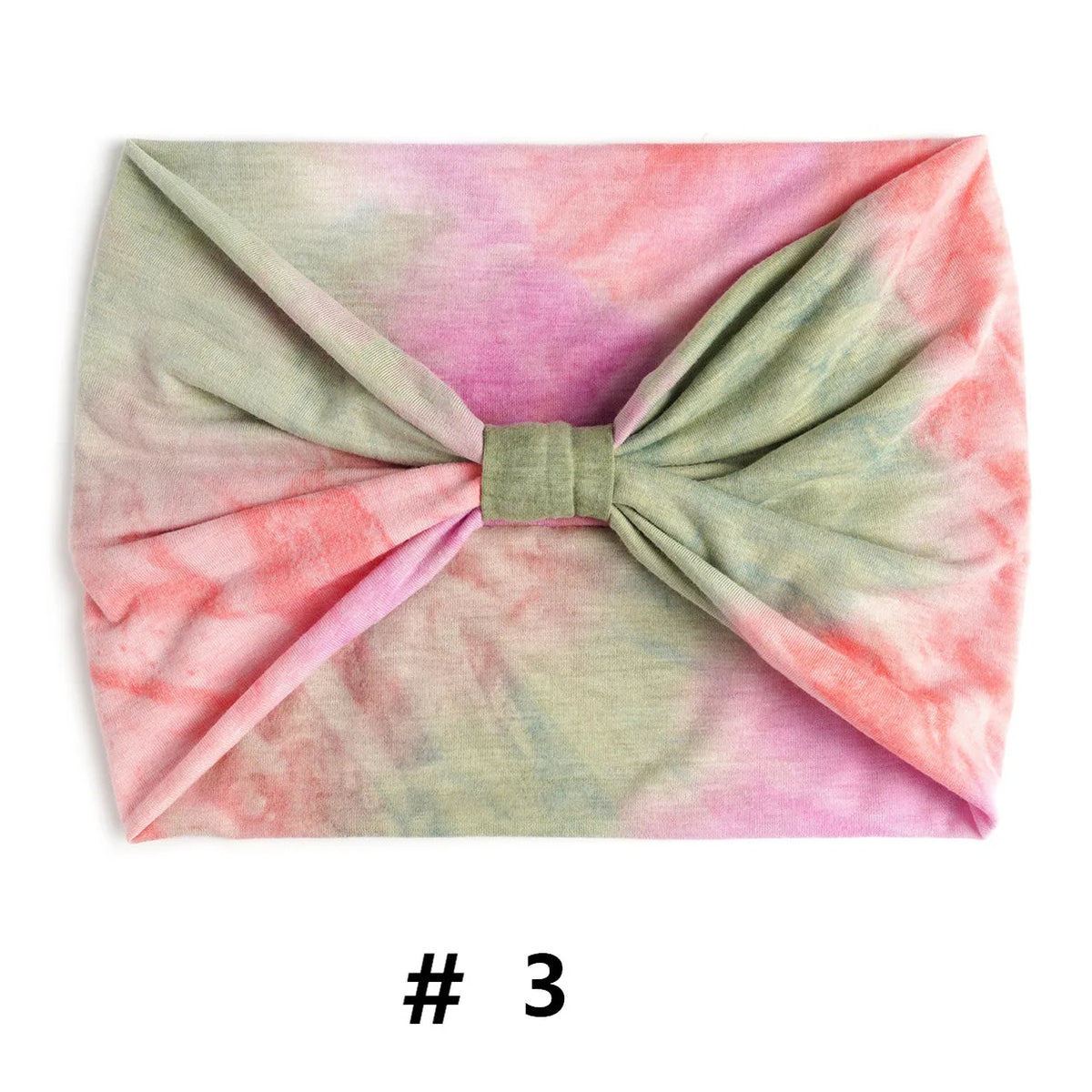 Un bandeau en coton tie-dye rose et vert, noué en nœud.