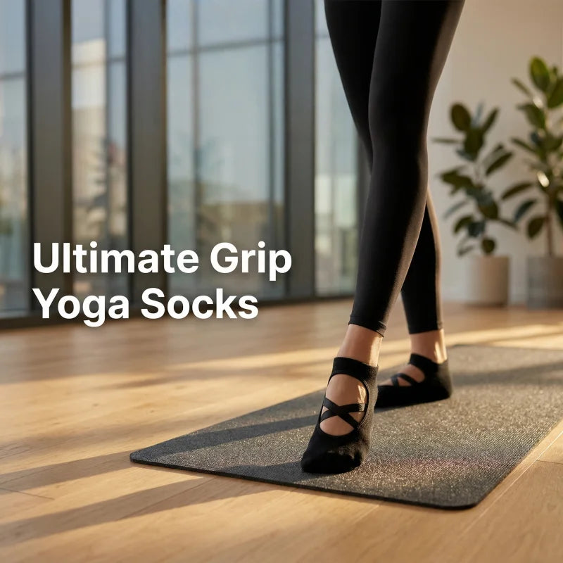 A pair of black crisscross strap yoga socks worn by a person on a yoga mat indoors.