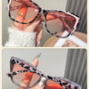 Pink hawksbill sunglasses featuring a leopard print pattern and pink frames