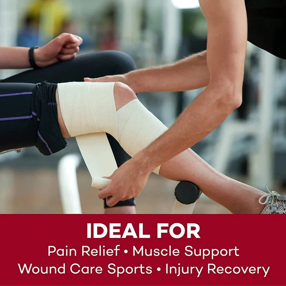 A person is applying a beige elastic compression bandage to an injured leg during sports recovery.