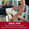A person is applying a beige elastic compression bandage to an injured leg during sports or first aid recovery.