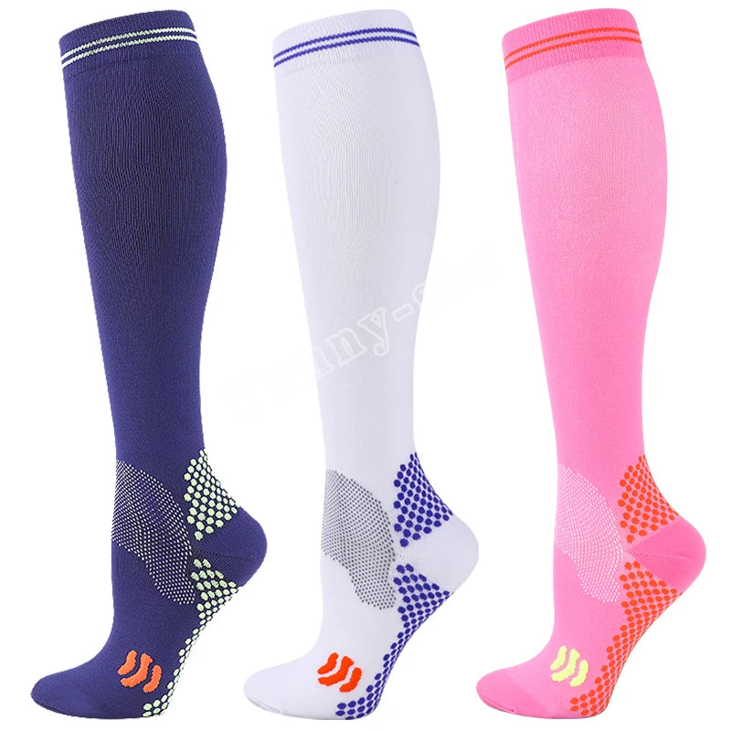 Three pairs of medical grade compression socks in navy blue, white, and pink with patterned toes.
