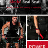 A muscular man lifts weights wearing black gear and red wrist straps in a gym setting.