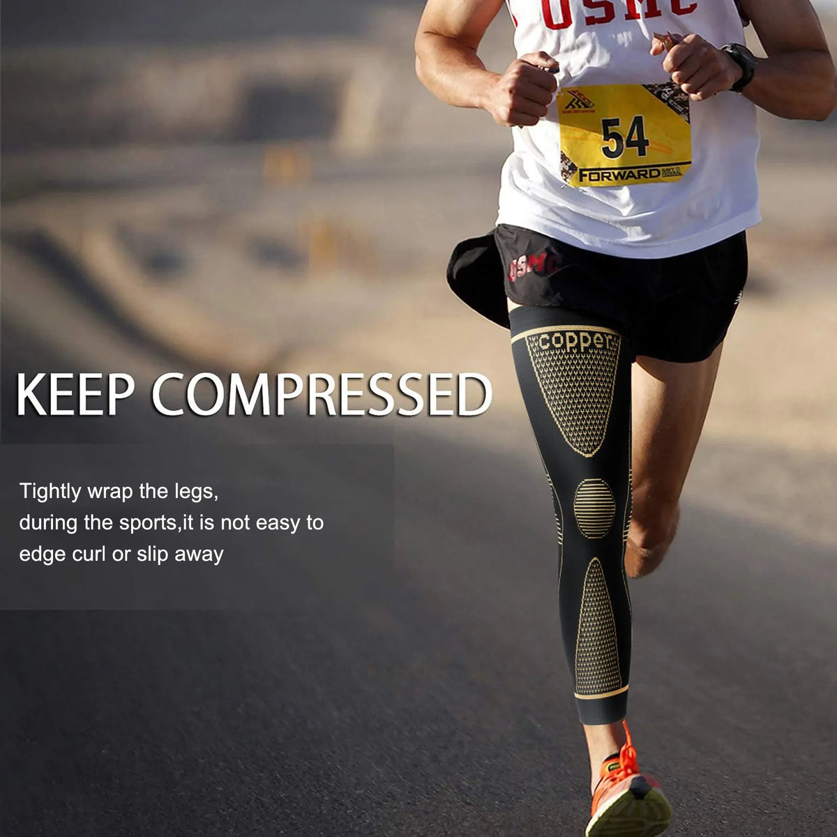 A runner wearing black compression sleeves on his legs while jogging outdoors.